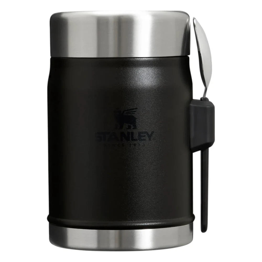 Stanley Adventure To-Go Food Jar and Spork 24oz in Matte Black front hero on white background showing assembled matte black jar with stainless steel lid, black spork clipped into side holder strap, and Stanley logo on the jar body