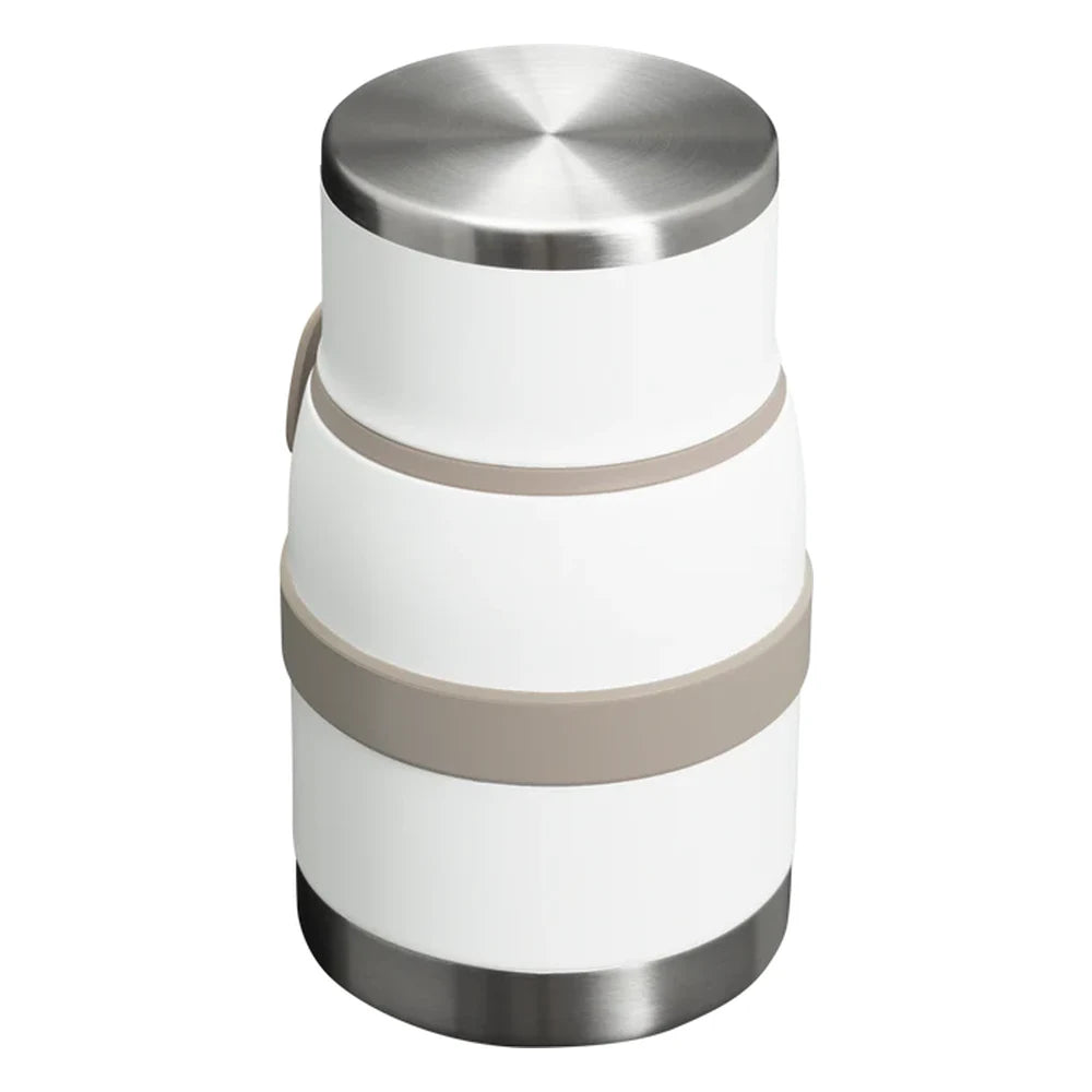Stanley Adventure To-Go Food Jar and Spork 24oz in Frost White back and top angle view on white background showing polished stainless steel lid top, white jar body with tan gray strap bands wrapped around the exterior