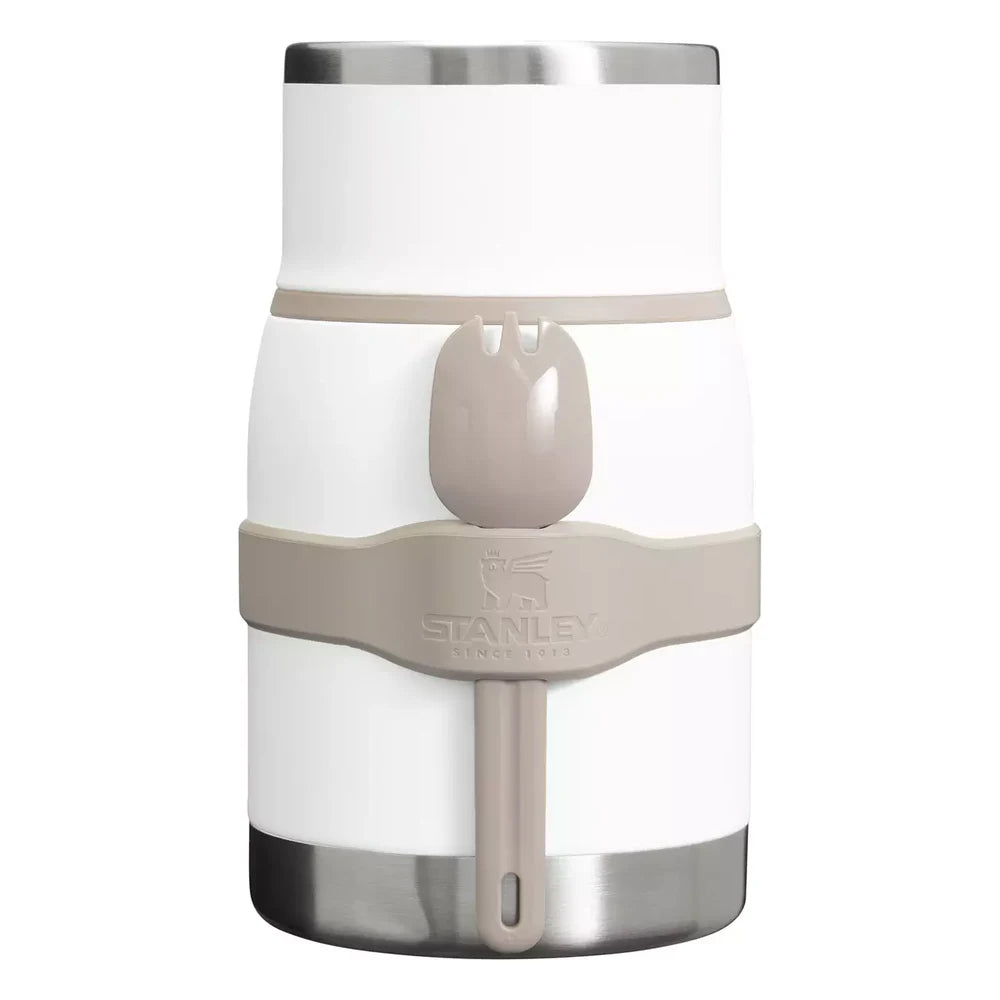Stanley Adventure To-Go Food Jar and Spork 24oz in Frost White front hero on white background showing assembled white jar with lid on, tan gray spork clipped into side holder strap, Stanley logo on strap, and brushed stainless steel base