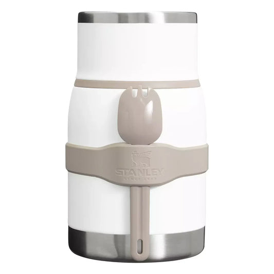 Stanley Adventure To-Go Food Jar and Spork 24oz in Frost White front hero on white background showing assembled white jar with lid on, tan gray spork clipped into side holder strap, Stanley logo on strap, and brushed stainless steel base