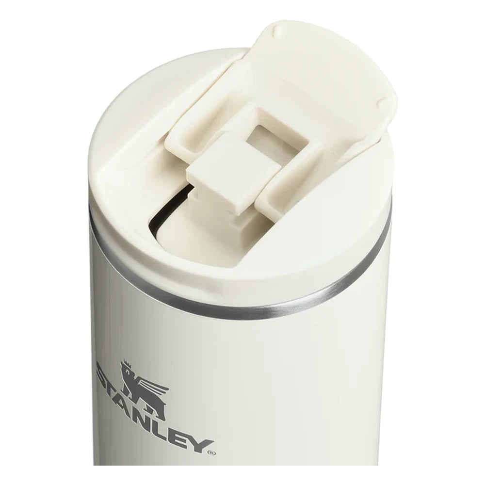 Stanley AeroLight Transit Bottle 20oz in Cream Gloss flip-top lid close-up detail on white background showing the cream lid flipped open revealing the drink opening with cream plastic inner mechanism, press-button latch, and stainless steel trim ring at the neck with Stanley logo visible below