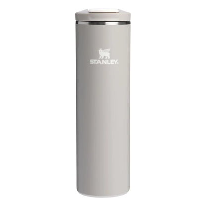 Stanley AeroLight Transit Bottle 20oz in Warm Gray front hero on white background showing slim warm gray matte cylindrical bottle with Stanley winged bear logo, stainless steel trim ring at the neck, and warm gray flip-top lid with press-button latch