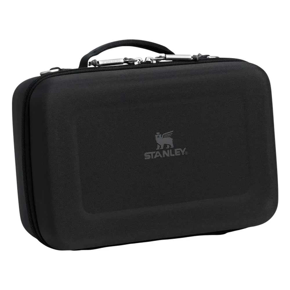 Stanley All Day Midi Lunch Box 6.3QT in Black three-quarter view on white background showing black hard-shell EVA lunch box with textured exterior, Stanley winged bear logo embossed on the front panel, top carry handle, and silver zipper pull hardware along the top edge