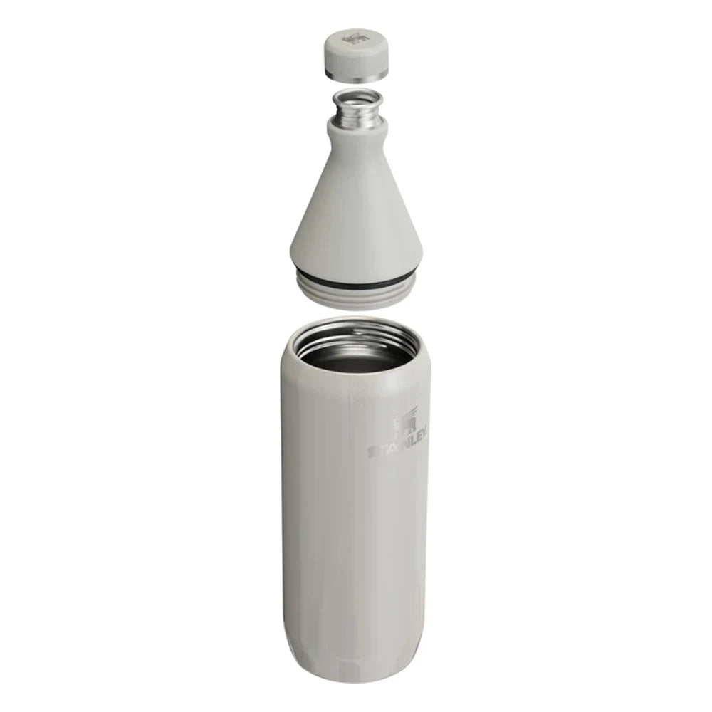 Stanley All Day Slim Bottle 34oz in Ash Gloss exploded view on white background showing all components separated: flat cap with Stanley bear icon floating above, the cone-shaped upper neck section with black sealing gasket and stainless steel threaded opening, and the cylindrical lower body with open stainless steel interior and Stanley logo
