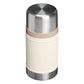 Stanley Classic Legendary Food Jar 24oz in Cream three-quarter elevated view on white background showing cream matte cylindrical body, large polished stainless steel dome lid from above, tan beige rubber gasket ring at the lid-body junction, and brushed stainless steel base