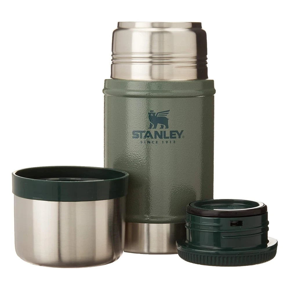 Stanley Classic Legendary Food Jar 24oz in Hammertone Green exploded view on white background showing all components separated: polished stainless steel dome outer lid at top center, stainless steel inner bowl lid to the lower left, dark green ridged screw-top inner stopper to the lower right, and the open hammertone green textured body with Stanley Since 1913 winged bear logo in the center
