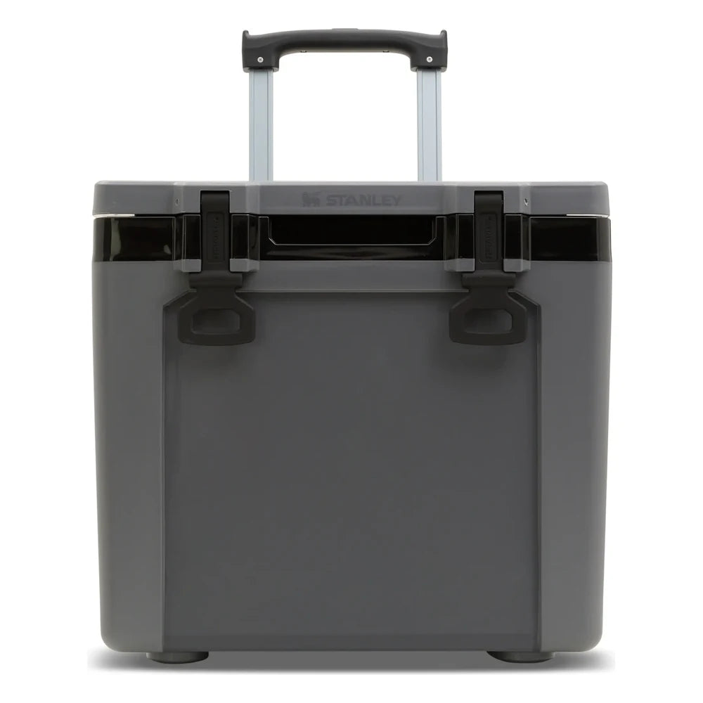 Stanley The Cold For Days Wheeled Outdoor Cooler 50QT in Charcoal Black front hero on white background showing gray charcoal body with two black D-ring latch handles, telescoping handle fully extended with black grip at the top, and Stanley logo on the lid with black trim accent