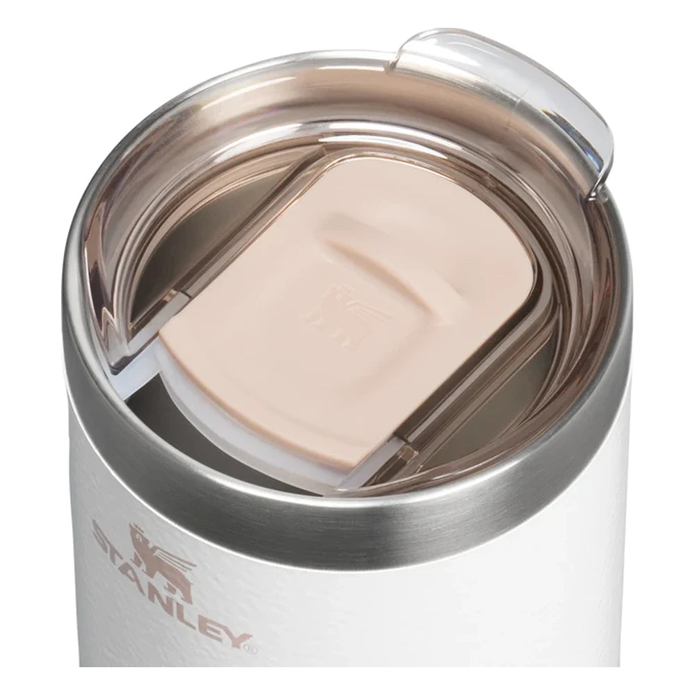 Stanley Every Day Camp Mug 12oz in Hammertone Frost top-angle three-quarter view on white background showing the brushed stainless steel lid with blush rose gold flip-tab sip cover closed, stainless steel collar, and white hammertone textured body