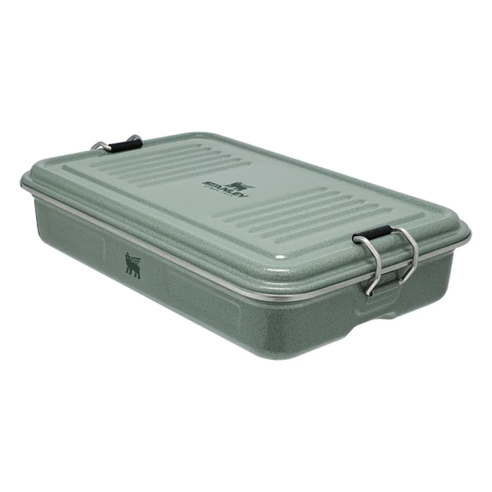 Stanley Legendary Classic Lunch Box three-quarter angle view on white background showing closed box in hammertone green enamel with ribbed lid, Stanley logo, bear icon on front face, and stainless steel bail latches on each side