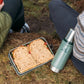 Stanley Legendary Useful Box 1.25 QT packed with a sandwich beside a Stanley bottle outdoors