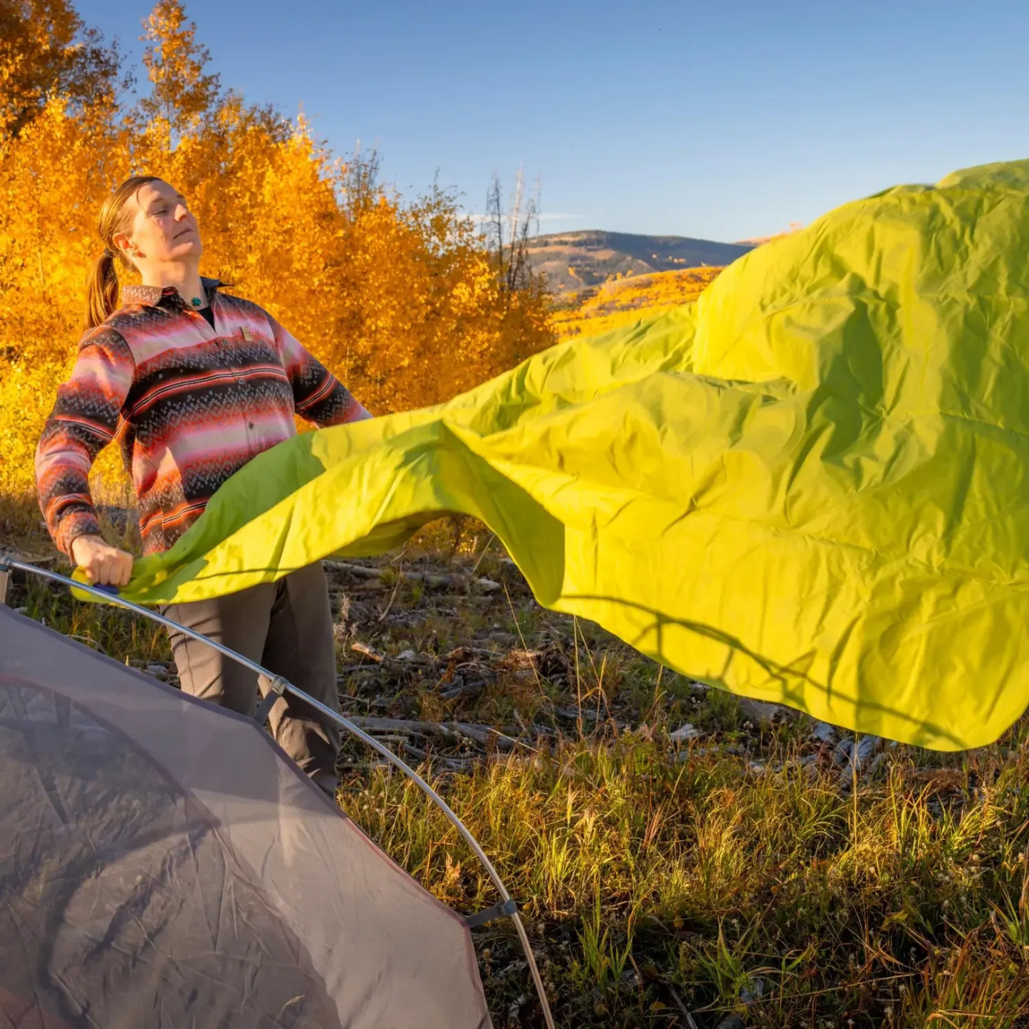 Setting up Klymit Static V Summit Double sleeping pad outdoors in mountains