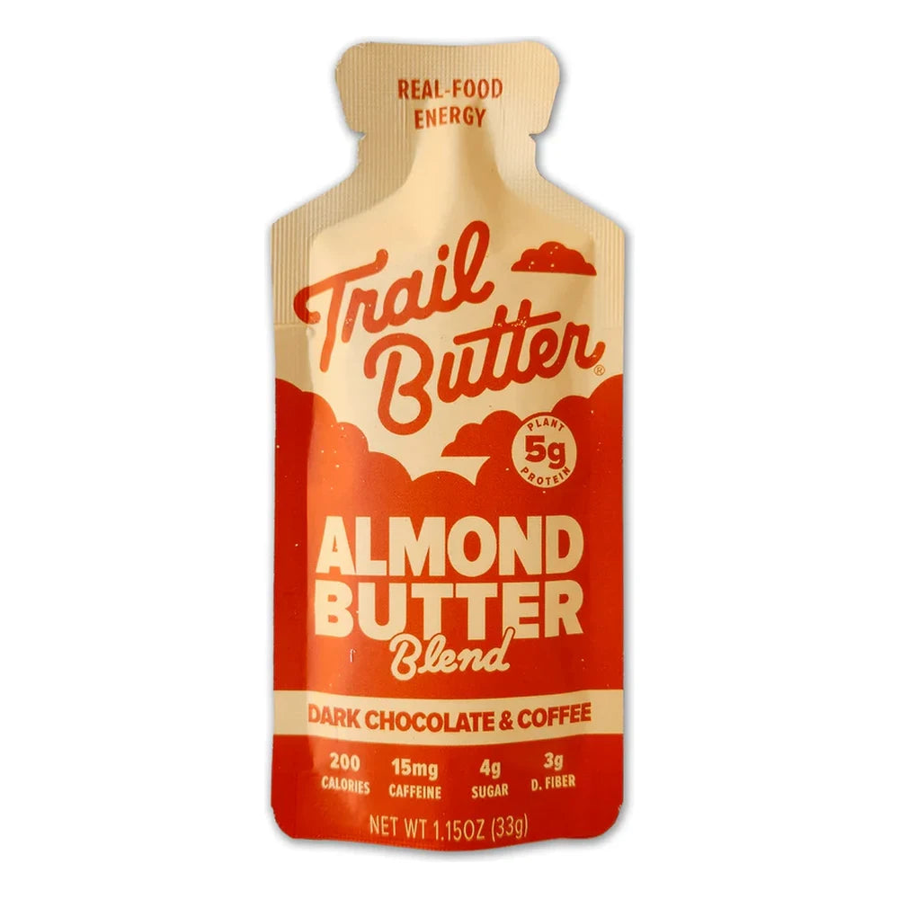 Trail Butter Dark Chocolate & Coffee Almond Butter Blend 1.15oz Lil' Squeeze packet front on white background showing tan and red-orange packet design, 5g plant protein badge, 200 calories, 15mg caffeine, Real-Food Energy tagline, and Almond Butter Blend Dark Chocolate and Coffee branding