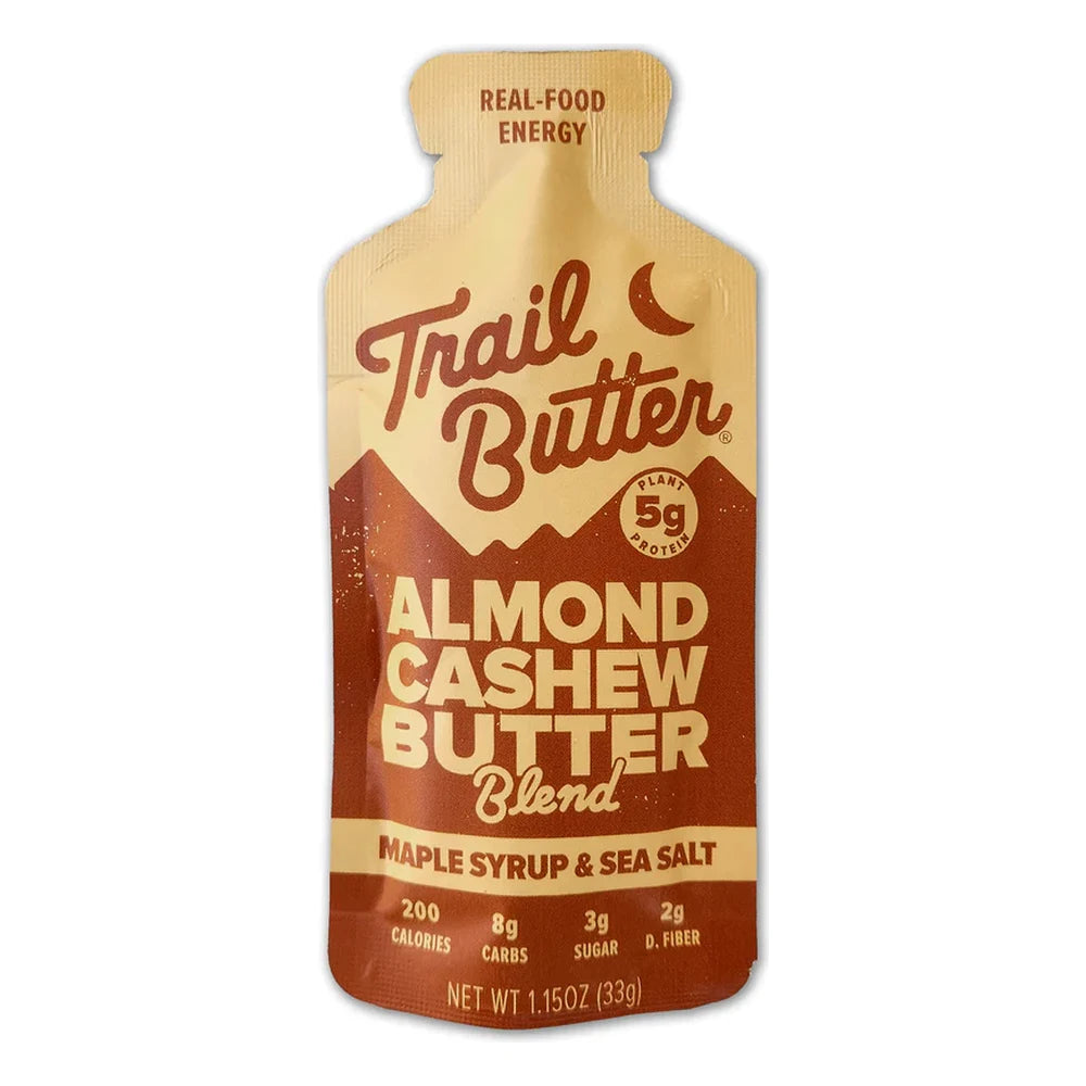 Trail Butter Maple Syrup & Sea Salt Almond Cashew Butter Blend 1.15oz Lil' Squeeze packet front on white background showing tan and brown packet design, 5g plant protein badge, 200 calories, Real-Food Energy tagline, and Almond Cashew Butter Blend Maple Syrup and Sea Salt branding