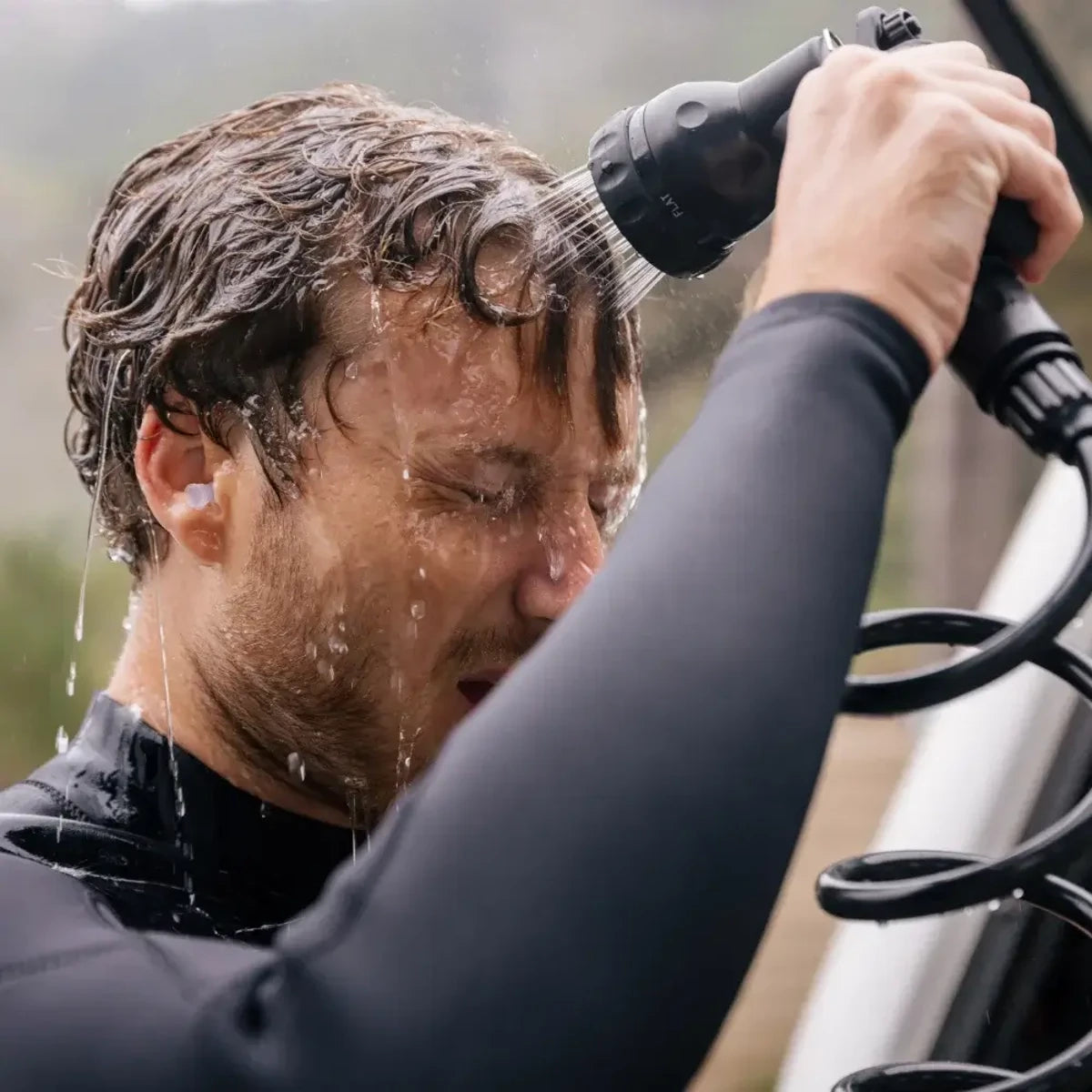 Rinsing face with pressurized spray from WaterPORT Overlander tank